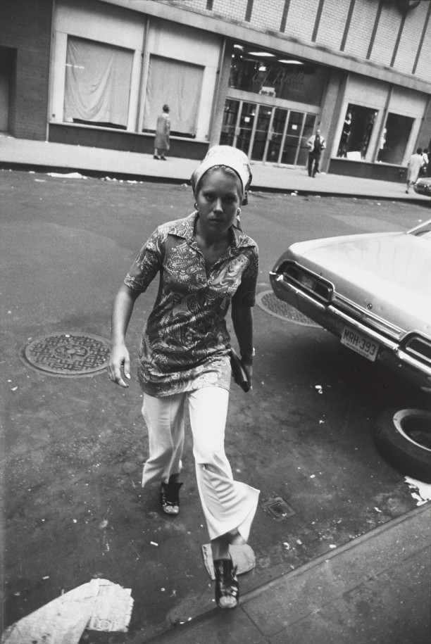 Untitled (Woman in a paisley shirt crossing a street)