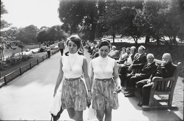 Untitled (Two women in identical shirts and skirts walking in a park)