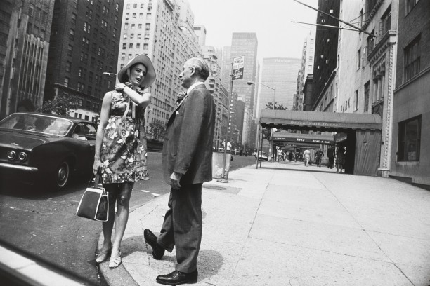 Untitled (Woman in floral dress and hat talking to a man on Park Avenue)