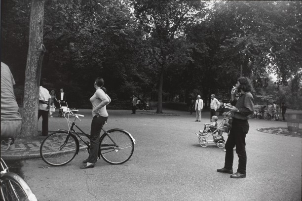 Untitled (Woman on a bicycle in park, looking away from the camera)