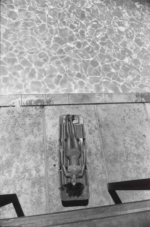 Untitled (A woman reclining on chair beside a pool)