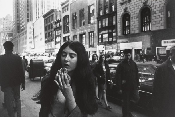 Untitled (Woman eating a pretzel on the street)