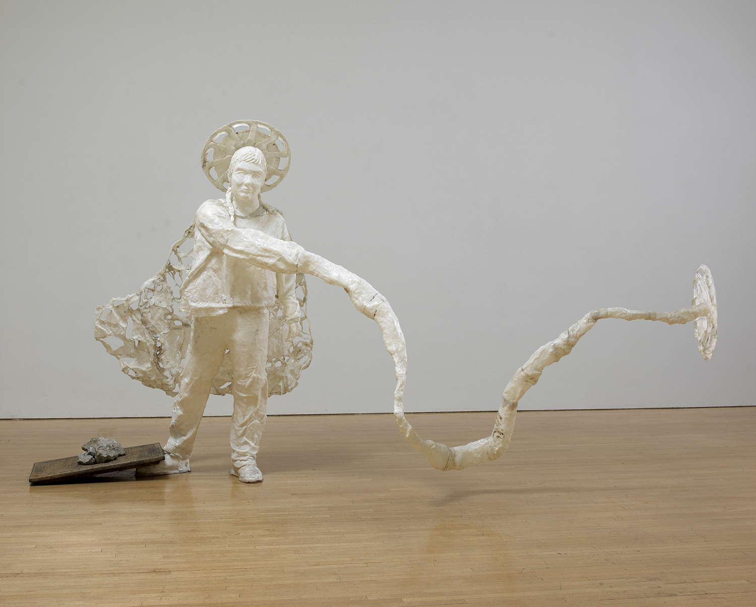 Katie Grinnan, Hubcap Woman, 2003. Friendly Plastic, concrete, and sewer cover. 63 3/8 x 115 x 46 in. (160.97 x 292.1 x 116.84 cm) Other (Sewer Cover): 5/8 x 23 5/8 x 15 3/4 in. (1.59 x 60.01 x 40.01 cm). The Museum of Contemporary Art, Los Angeles Purchase with funds provided by the Curatorial Discretionary Fund