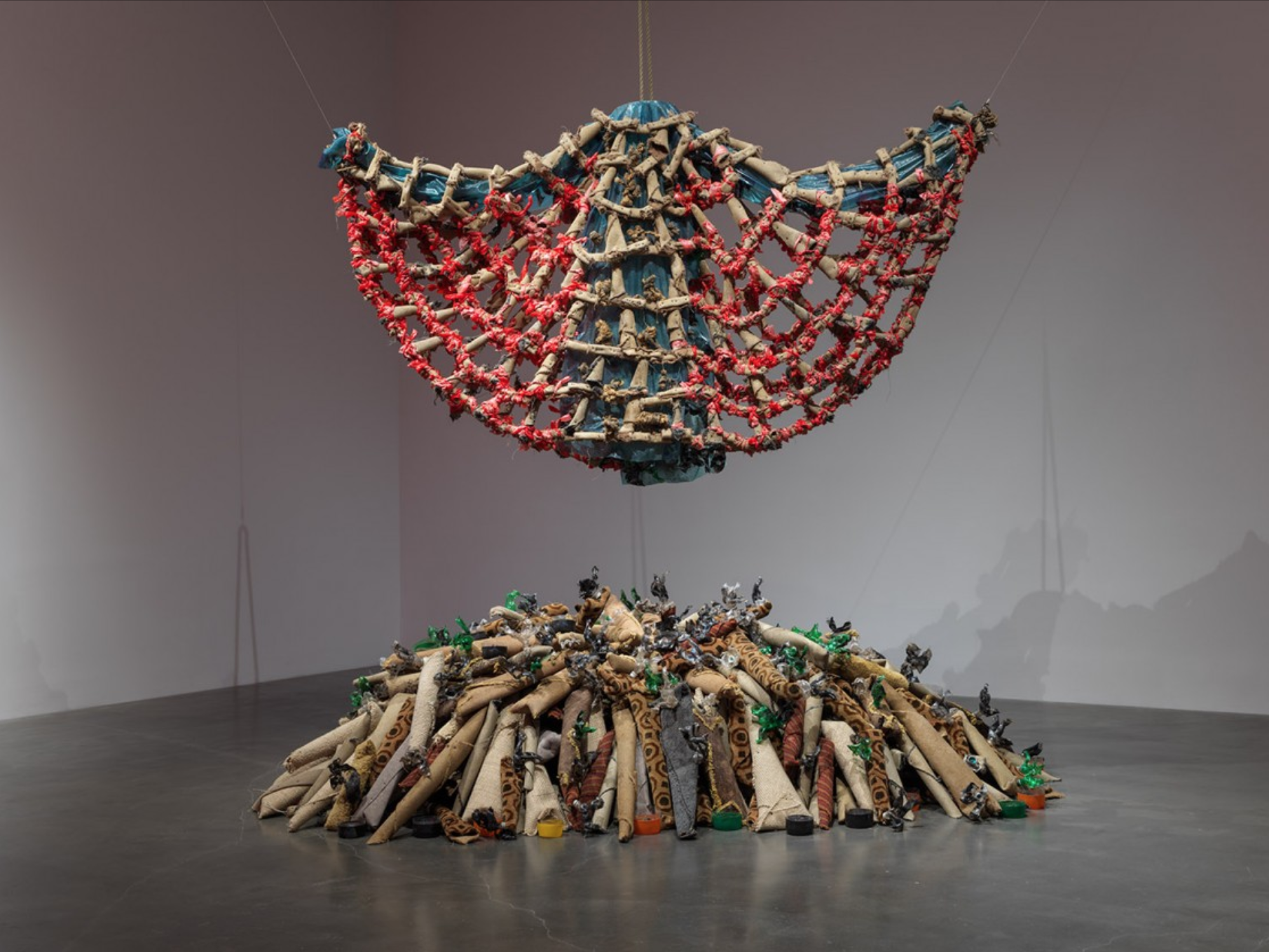 Nari Ward, Carpet Angel, 1992, Carpet, plastic bags, plastic bottles, vinyl carpet runner, springs, wood screws, and rope.